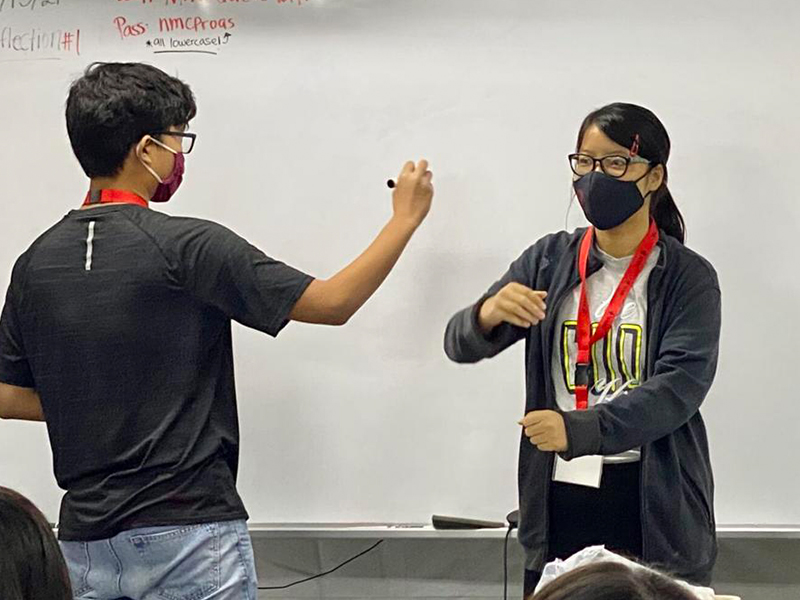 Two students perform an activity